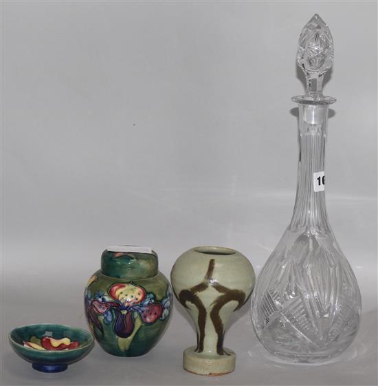 A Moorcroft lidded pot and dish, a decanter and a pottery vase